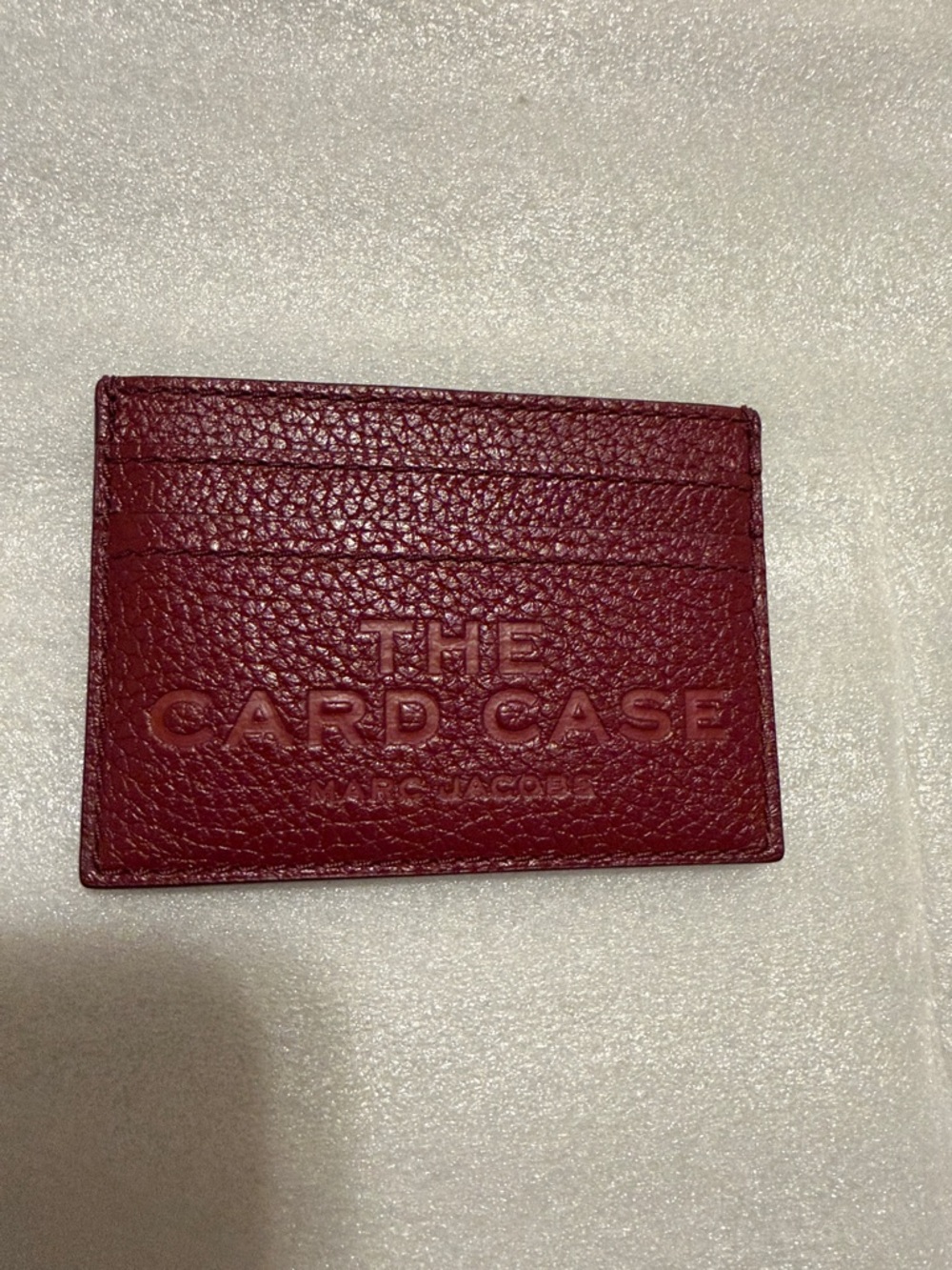 Marc Jacobs Pebbled Leather Card Holder in the color cherry.